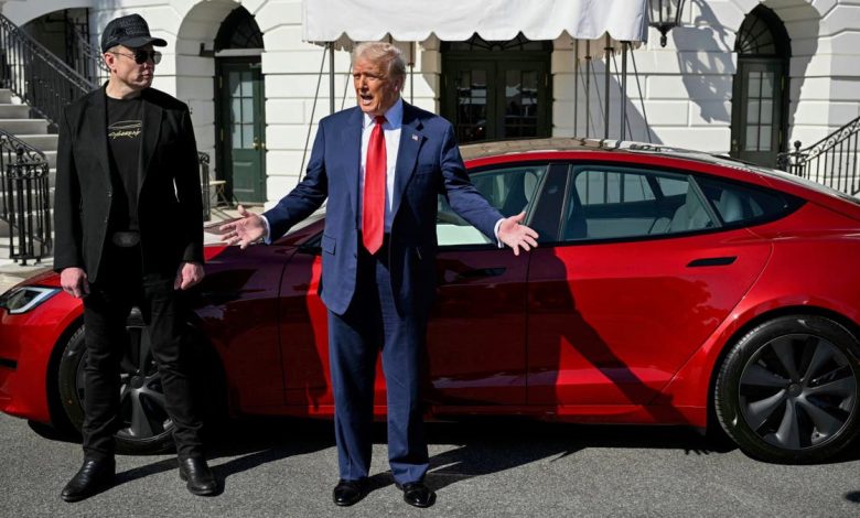 President Donald Trump, right, and Tesla CEO Elon Musk speak to reporters near a red Model S Tesla vehicle on the South Lawn of the White House on Tuesday, March 11, 2025 in Washington, D.C.