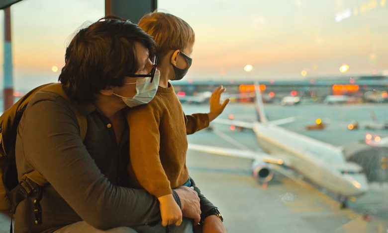 Father and son traveling in an airport