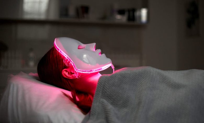 Person in red light therapy mask.