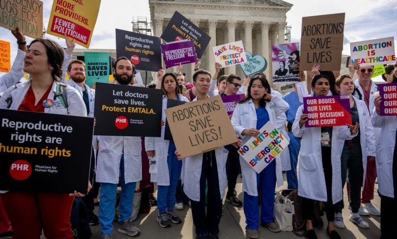 Doctors join abortion rights supporters at a rally outside the Supreme Court