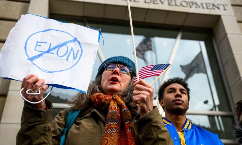 Protester holding up an anti-Elon Musk sign