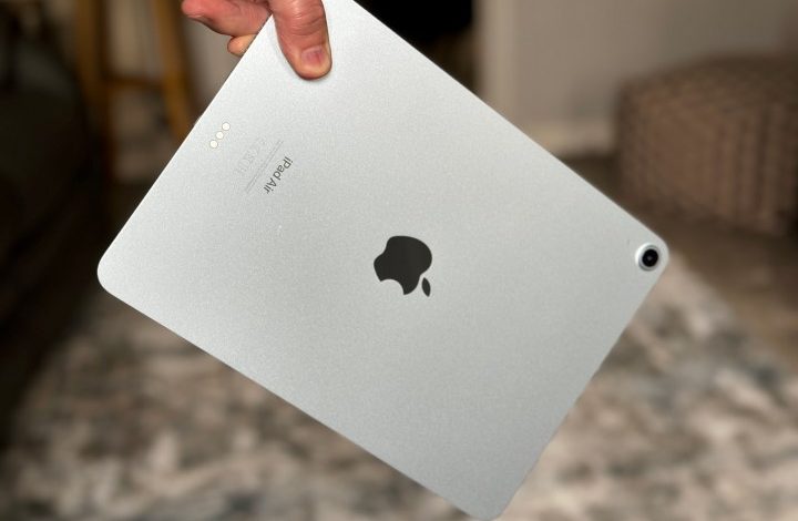 A person holding the iPad Air M2.