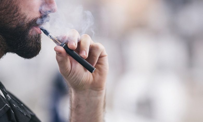 man smoking a vape