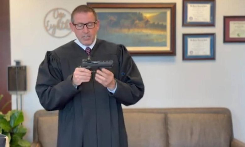 Judge in video holding gun