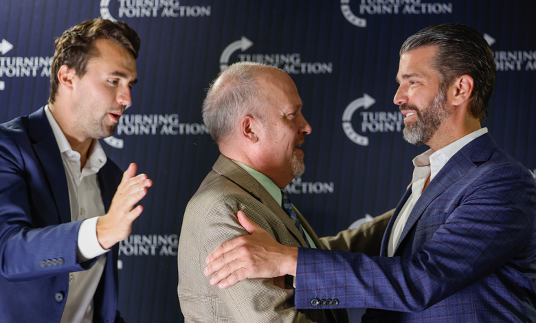 Former Wisconsin Attorney General and state Supreme Court candidate Brad Schimel, middle, greets Donald Trump Jr., as Charlie Kirk looks on during a town hall Monday, March 17, 2025, in Oconomowoc, Wis. (AP Photo/Jeffrey Phelps)