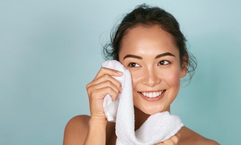 woman patting face dry