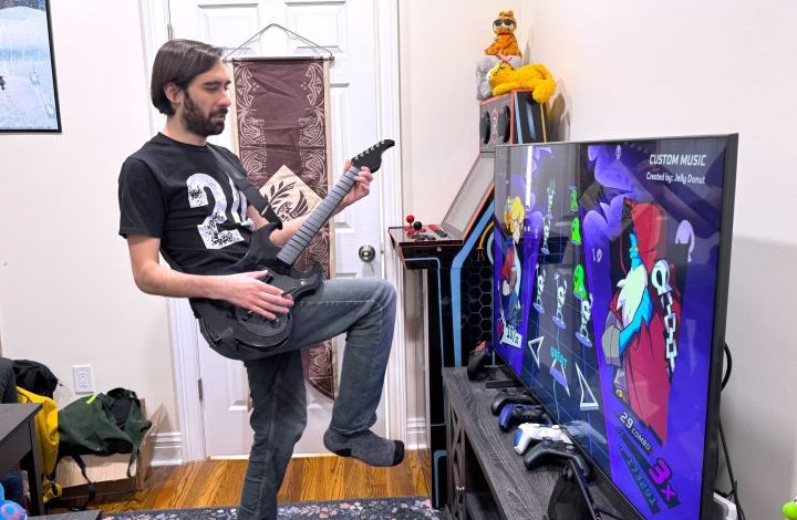 A man plays Rift of the Necrodancer with a PDP Riffmaster.