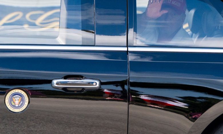 President Donald Trump waves as he departs in his motorcade from the Trump International Golf Club, Saturday, in West Palm Beach, Fla. 