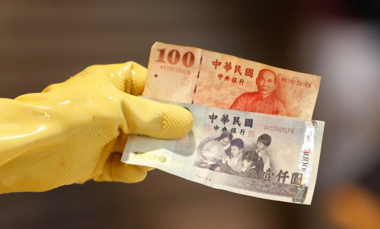Taiwan dollar eases after historic surge as officials deny currency talks with U.S.