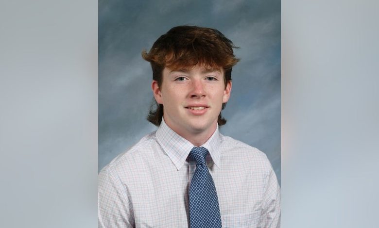 James McGrath smiles and wearing a tie