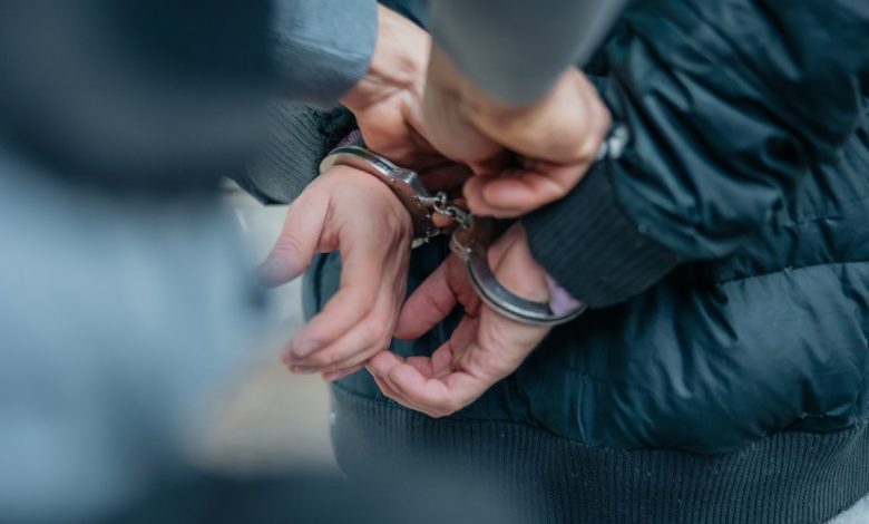 Criminal being put into handcuffs