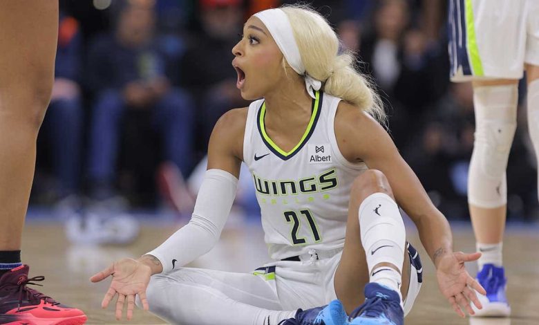 DiJonai Carrington pushes back after referees call security during Wings game