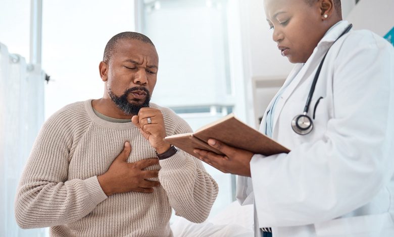 man coughs while being seen by doctor