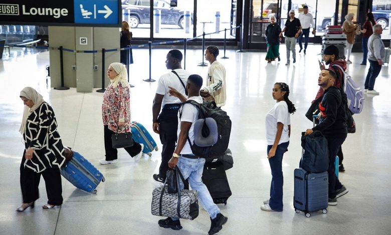 passengers walk through newark airport