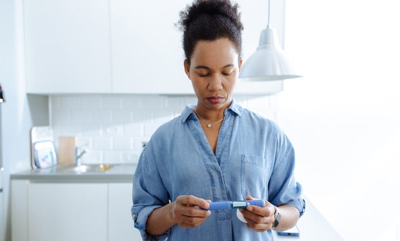 A woman prepares to administer an insulin injection