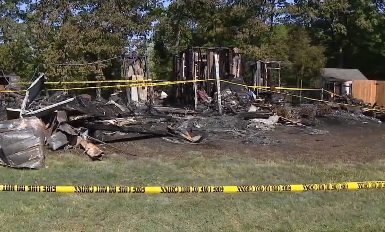 burnt and demolished house ruins with caution tape around