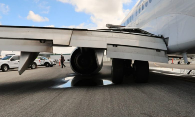 left airplane wing touching tarmac