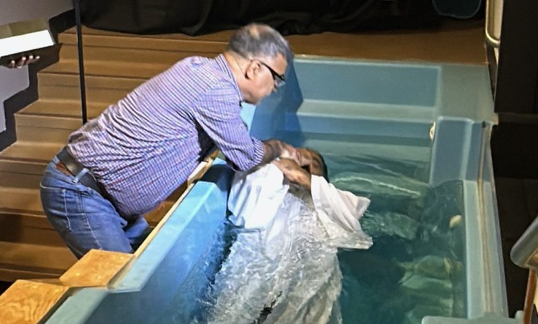 Pastor Basir baptizes a man in a small indoor pool during a church service at Oklahoma Khorasan Church, which serves Afghan Christian refugees