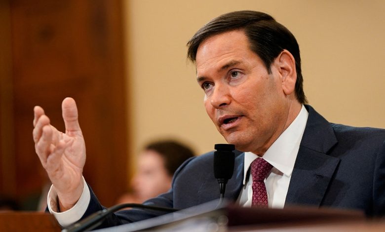 Secretary of State Marco Rubio gestures with his hand while he testifies