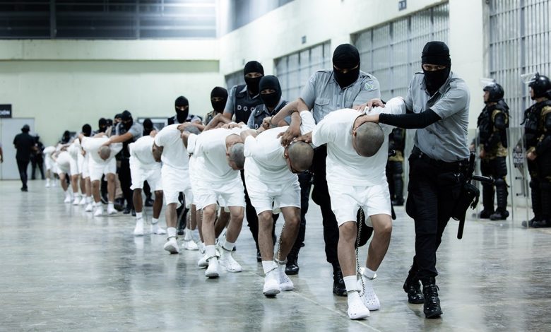 El Salvador guards bring in prisoners with their heads shaved