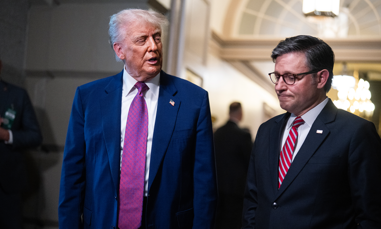 Donald Trump stands next to Mike Johnson