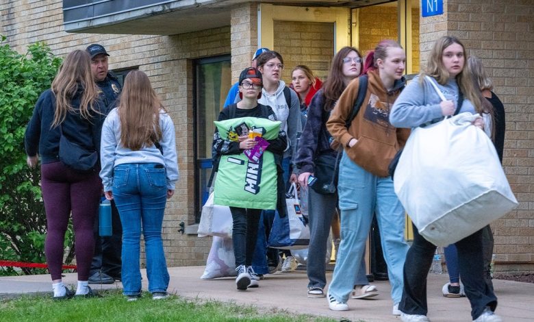 Students leave with their belongings from Wilgus Hall