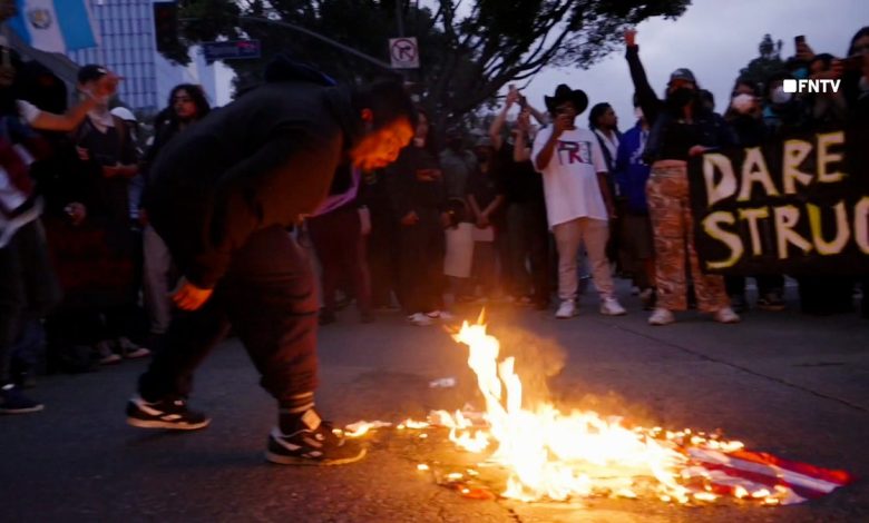 A man spits on a burning American flag in Los Angeles.