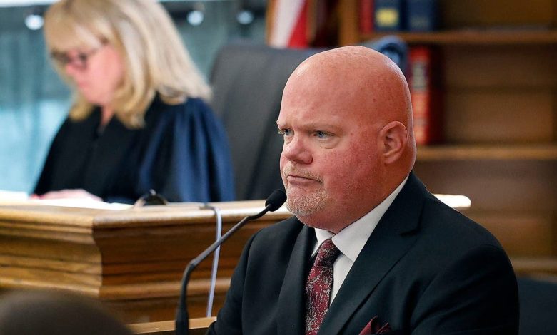 Canton DPW snowplow driver Brian Loughran on the witness stand, with judge Beverly Cannone in the background