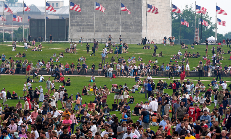 People on the lawn around the Washington Monument as President Donald Trump attends a military parade commemorating the Army's 250th anniversary on Saturday, June 14, 2025, in Washington.