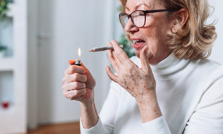 older woman lights up marijuana joint
