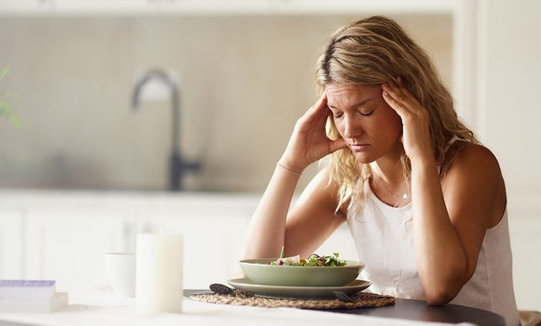 woman sad eating a salad