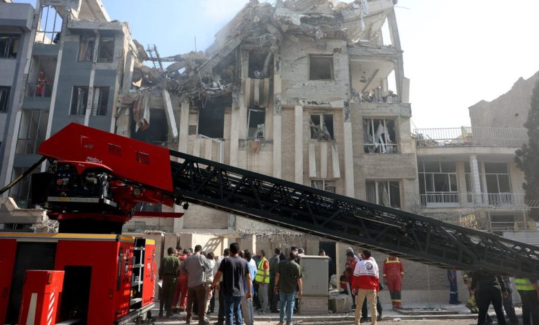 Rescue teams work outside a heavily damaged building, targeted by an Israeli strike in the Iranian capital Tehran on June 13, 2025.