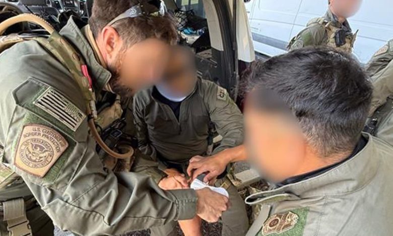 A Border Patrol agent receives medical attention after being injured by a flying rock.