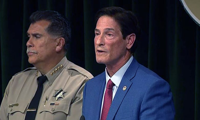 Nathan Hochman speaks at a press conference as Sheriff Robert Luna listens beside him