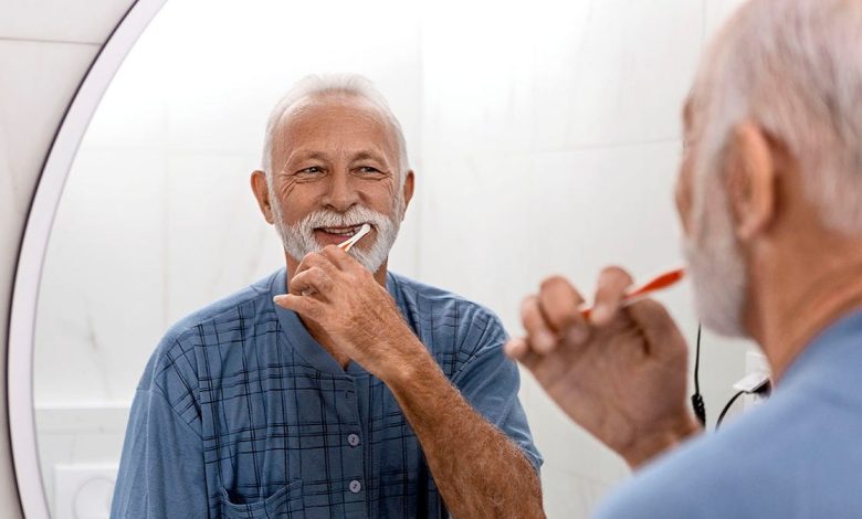 Senior man keeping his dental hygiene in check by brushing