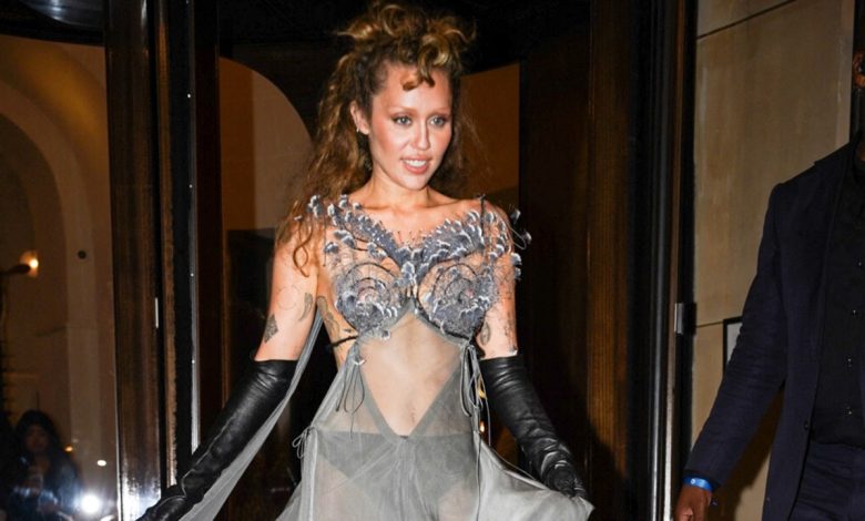 Miley Cyrus shows off toned abs in peacock-feathered sheer dress in Paris