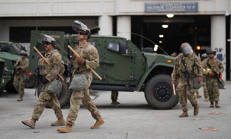 U.S. National Guard troops walking by vehicle