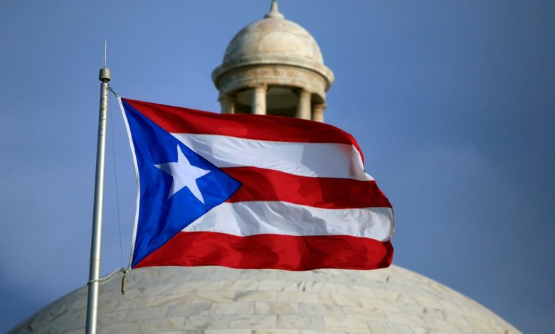 FILE - In this July 29, 2015 file photo, the Puerto Rican flag flies in front of Puerto Rico's Capitol as in San Juan, Puerto Rico. Puerto Rico's governor is pushing ahead with his top campaign promise of trying to convert the U.S. territory into a state, holding a Sunday June 11, 2017, referendum to let voters send a message to Congress. (AP Photo/Ricardo Arduengo, File)