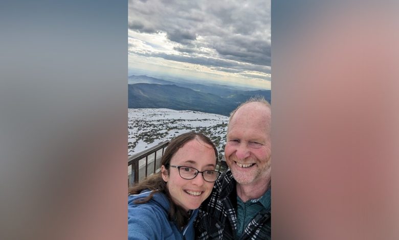 Tim and Esther Keiderling selfie with mountain behind them