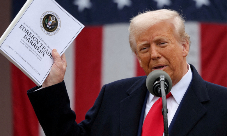 Donald Trump holds up document titled, "Foreign Trade Barriers"
