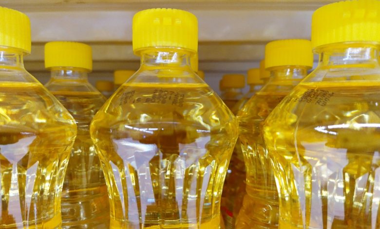 Bottles of vegetable oils with yellow caps are shown.