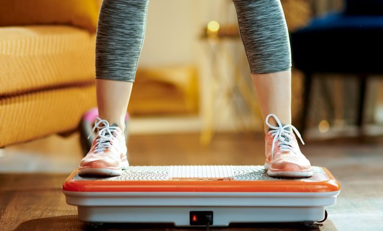 woman using a vibration plate at home
