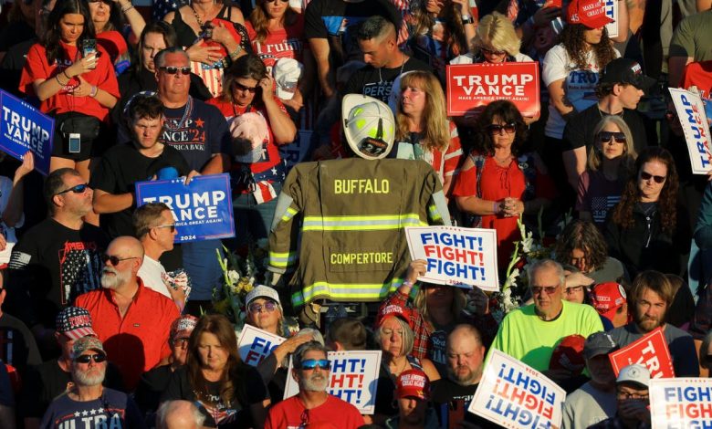 Corey Comperatore’s turnout coat is displayed in the crowd during a moment of silence at a Trump rally in Butler, Pa., honoring the slain volunteer fire chief.