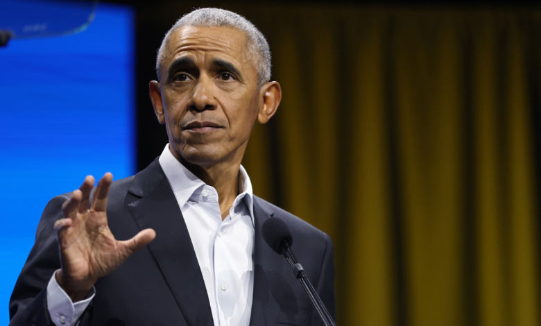 Former U.S. President Barack Obama with his hand up while speaking