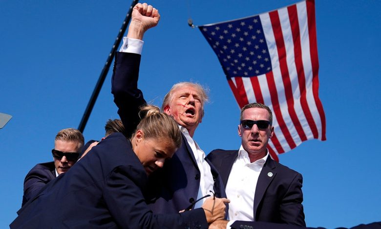 Former President Donald Trump is surrounded by U.S. Secret Service agents at a campaign rally
