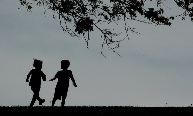 Children run on the lawn