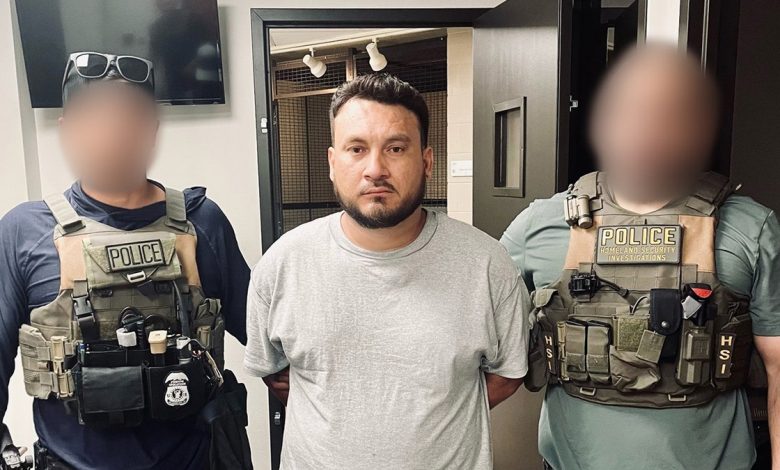 Honduran national held on each arm by ICE agents after being taken into custody