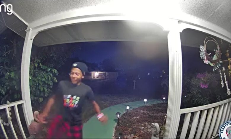 A person kicks in a door on security camera footage