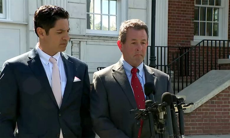 Kevin McGrath (right) speaks outside Milford, Connecticut courthouse in gray suit and red tie