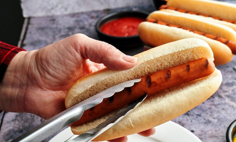 Man preparing hot dog